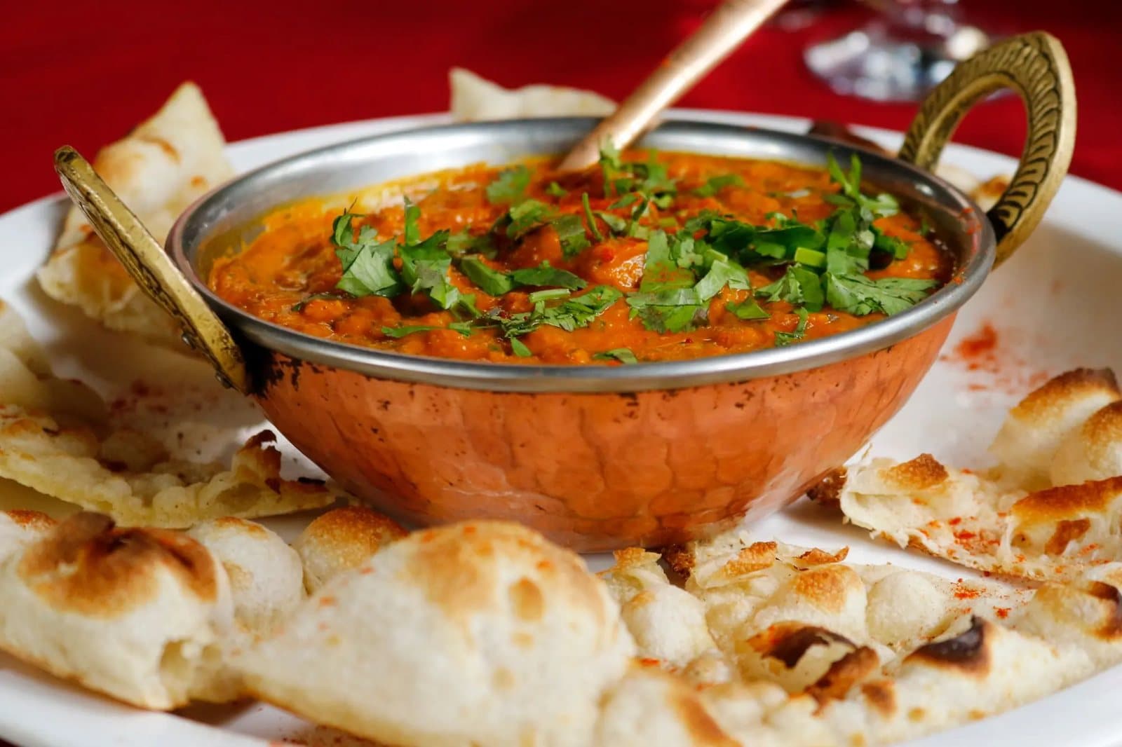Naan Cafe curry and naan on a table.